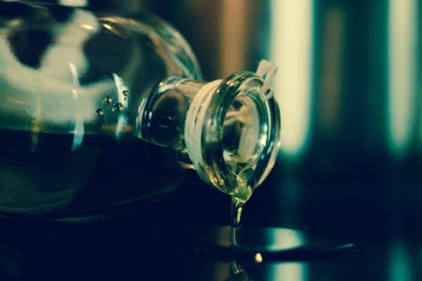 A bottle of Cannabis oil spilling onto a counter